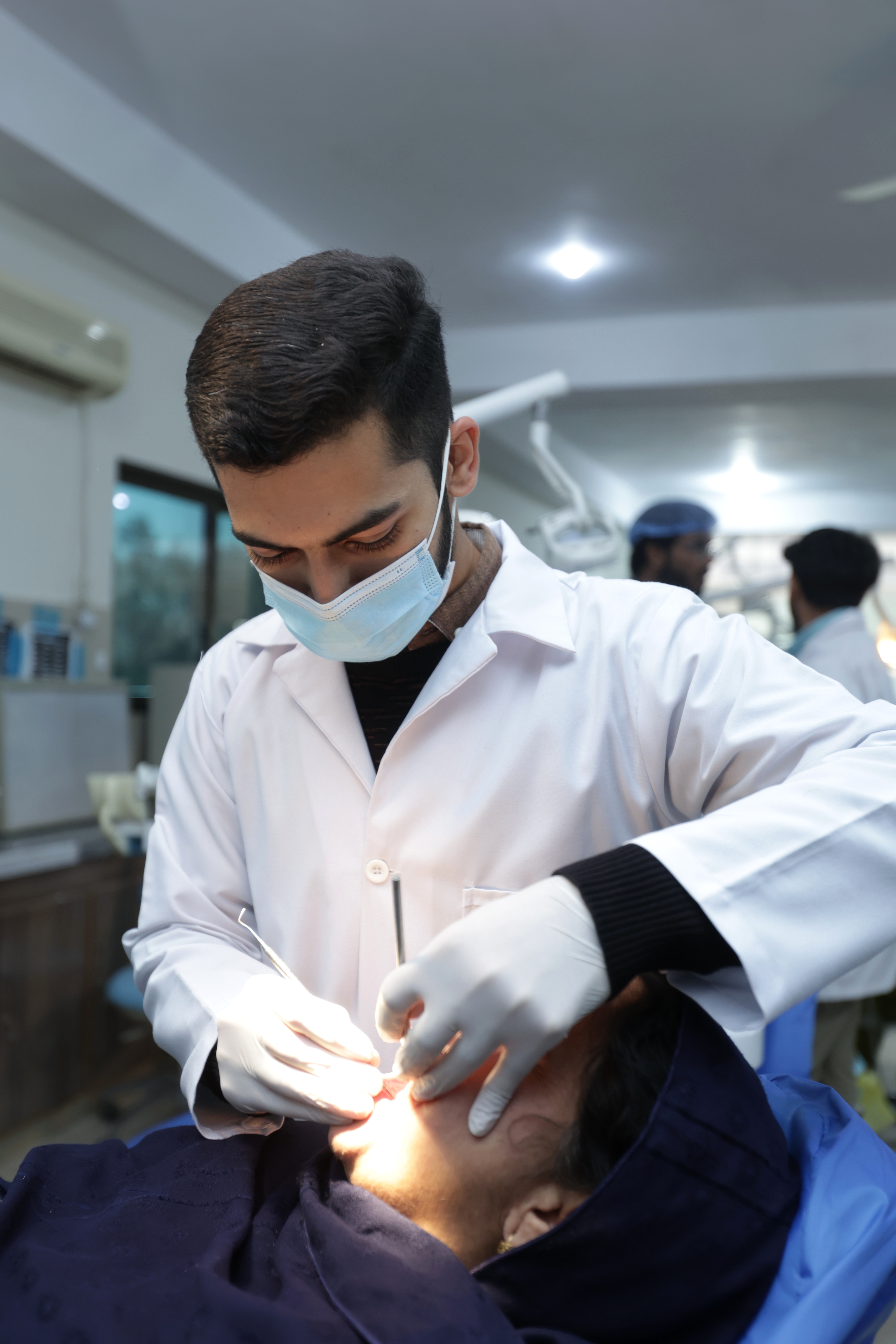 Dr. Syed Hammad Hussain Shah providing dental treatment at Punjab Dental Hospital